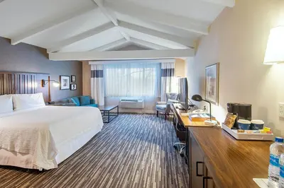 a hotel room with a bed and a desk at Best Western Premier Plainview-Long Island Hotel in Plainview