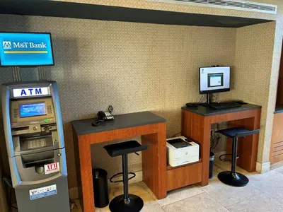 a room with an atm machine and a desk and stools at Best Western Premier Plainview-Long Island Hotel in Plainview