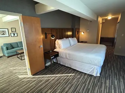 a hotel room with a large bed and a couch at Best Western Premier Plainview-Long Island Hotel in Plainview