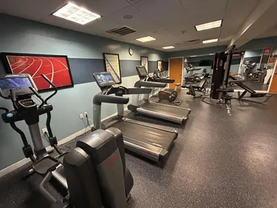 a gym with several treadmills and cardio machines at Best Western Premier Plainview-Long Island Hotel in Plainview