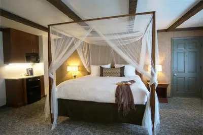 a bedroom with a bed with a canopy at The Yankee, Trademark Collection by Wyndham in Lenox