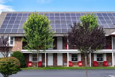 a building with solar panels on the roof at The Yankee, Trademark Collection by Wyndham in Lenox