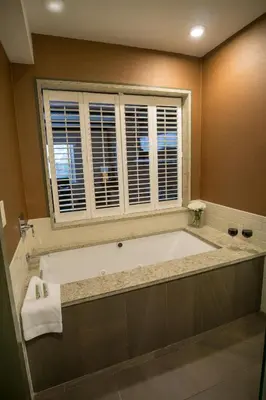 a large bath tub in a bathroom with a window at The Yankee, Trademark Collection by Wyndham in Lenox