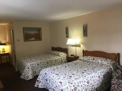 a hotel room with two beds and two lamps at Catamount Motel in Bennington