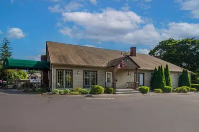 a building with a flag on the front of it at Quality Inn Great Barrington in Great Barrington