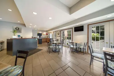 a restaurant with chairs and tables and a bar at Quality Inn Great Barrington in Great Barrington