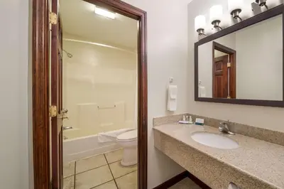 a bathroom with a sink and a toilet and a mirror at Quality Inn Great Barrington in Great Barrington