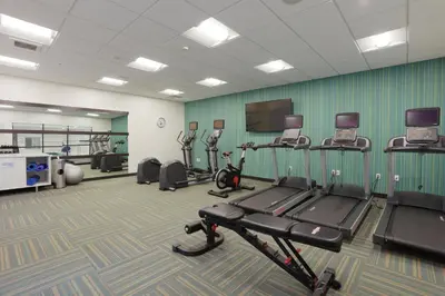 a gym with several treadmills and cardio machines at Holiday Inn Express Oneonta by IHG in Oneonta