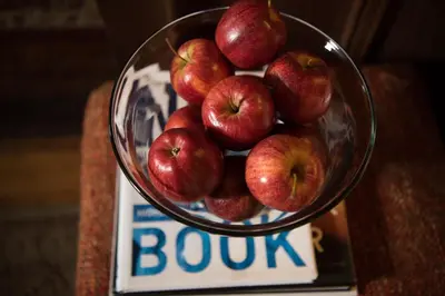 a bowl of apples sitting on top of a box at Harlem Grand in New York