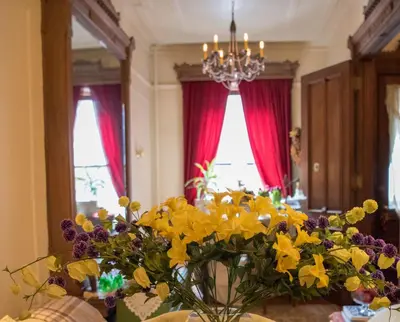 a vase filled with yellow flowers on a table at Harlem Grand in New York