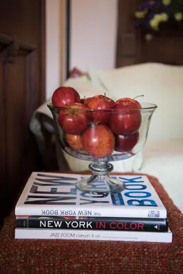 a bowl of apples sitting on top of a book at Harlem Grand in New York