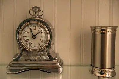 a silver clock sitting on top of a table at Harlem Grand in New York
