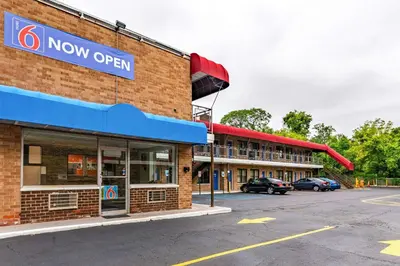 a now open sign on the side of a building at Motel 6-Elmsford, NY - White Plains in Elmsford