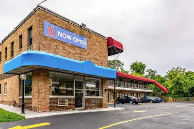 a now open sign on a brick building at Motel 6-Elmsford, NY - White Plains in Elmsford