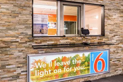 a sign that says well leave the light on for you at Motel 6-Elmsford, NY - White Plains in Elmsford
