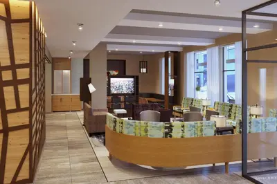 a lobby of a hotel with a waiting room at TownePlace Suites by Marriott New York Manhattan/Times Square in New York