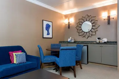 a waiting room with blue chairs and a table at Sheraton Tarrytown Hotel in Tarrytown