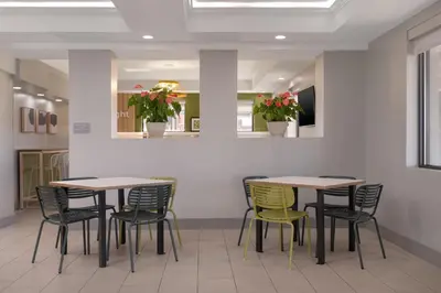 a row of tables and chairs in a waiting room at Spark by Hilton Fishkill in Fishkill