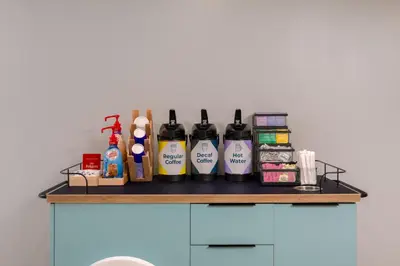 a shelf with grooming products on top of a cabinet at Spark by Hilton Fishkill in Fishkill