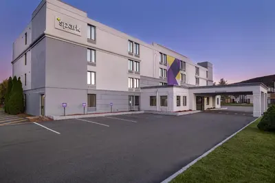 a large white building with a parking lot at Spark by Hilton Fishkill in Fishkill