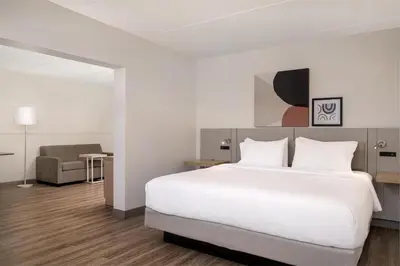 a hotel room with a bed and a chair at Spark by Hilton Fishkill in Fishkill