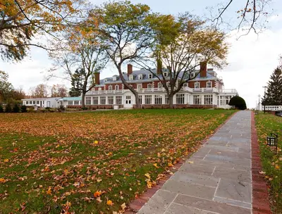 a large white house with a pathway in front of it at Eastover Estate and Eco Village in Lenox