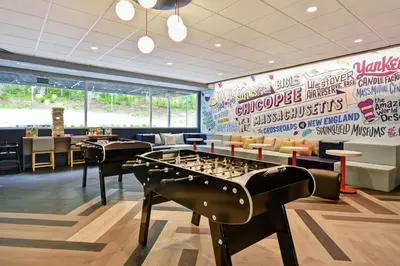 a billiard room with a large wall of graffiti at Tru By Hilton Chicopee Springfield in Chicopee