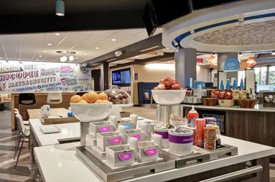 a buffet line with bowls of fruit and other food at Tru By Hilton Chicopee Springfield in Chicopee