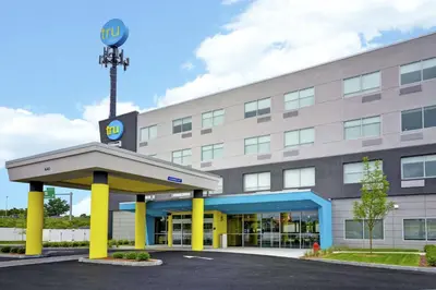 a building with a krispy kreme sign on it at Tru By Hilton Chicopee Springfield in Chicopee
