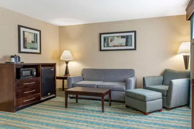a living room with a couch and a tv at Best Western Plus Berkshire Hills Inn & Suites in Pittsfield