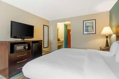 a hotel room with a bed and a flat screen tv at Best Western Plus Berkshire Hills Inn & Suites in Pittsfield
