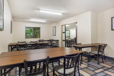 a dining room with wooden tables and chairs at Best Western Plus Berkshire Hills Inn & Suites in Pittsfield