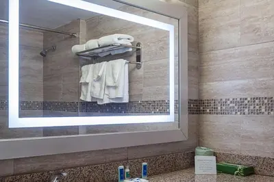 a bathroom with a mirror and a sink at Rodeway Inn Meadowlands in Secaucus