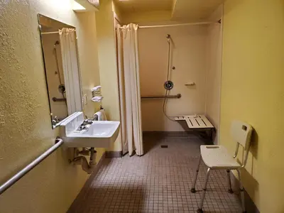 a bathroom with a sink and a shower at Travel Inn Motel in Hartford