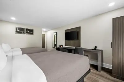 a hotel room with a bed and a desk at Quality Inn in West Haven