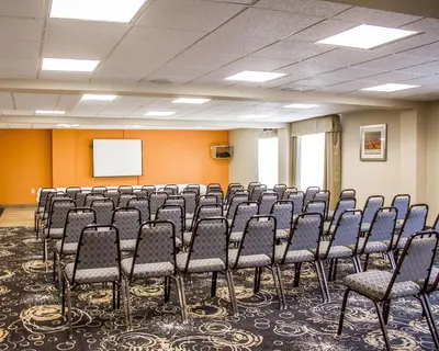 a conference room with chairs and a white screen at Comfort Inn Wethersfield - Hartford in Wethersfield
