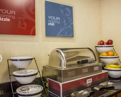 a kitchen with bowls of fruit and a cash register at Comfort Inn Wethersfield - Hartford in Wethersfield