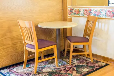 two chairs sitting next to a table and a table at Rodeway Inn & Suites Branford - Guilford in Branford