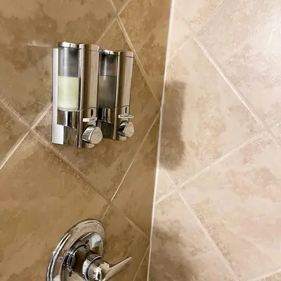 a shower stall with a silver sink and a facet at Baseball Town Motel in Cooperstown