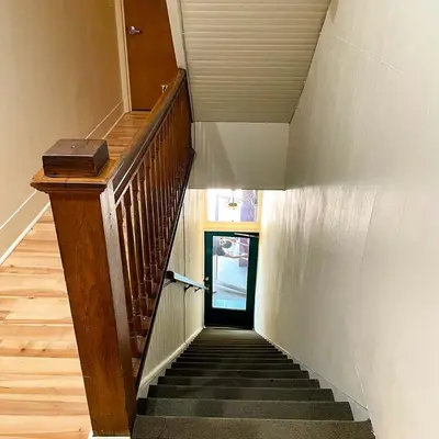 a stairway with a wooden railing and a stair case at Baseball Town Motel in Cooperstown