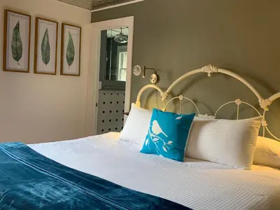 a bedroom with a large bed with white pillows at The Nutmeg Vermont in Wilmington