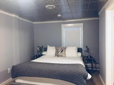 a bedroom with a large bed with a blue wall at The Nutmeg Vermont in Wilmington