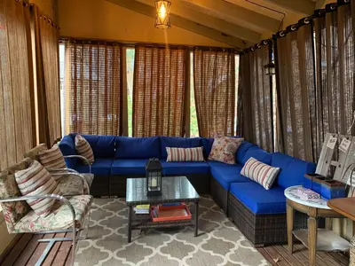 a living room with a blue couch and a table at Starlite Motel & Suites in Big Indian