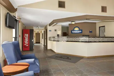 a lobby of adq inn with chairs and a bar at Days Inn by Wyndham Middletown in New Hampton
