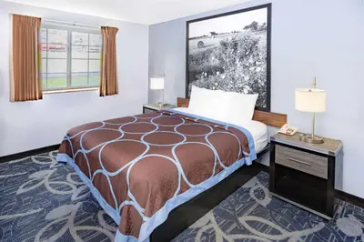 a hotel room with a bed and a window at Super 8 by Wyndham Johnstown/Gloversville in Johnstown