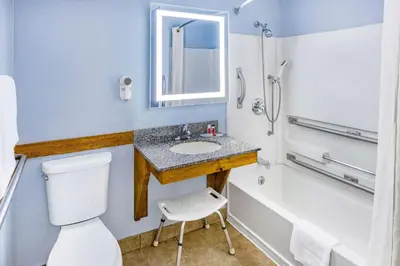 a bathroom with a sink and a toilet and a tub at Super 8 by Wyndham Johnstown/Gloversville in Johnstown