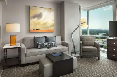 a living room with a couch and a chair at Homewood Suites By Hilton Teaneck Glenpointe in Teaneck