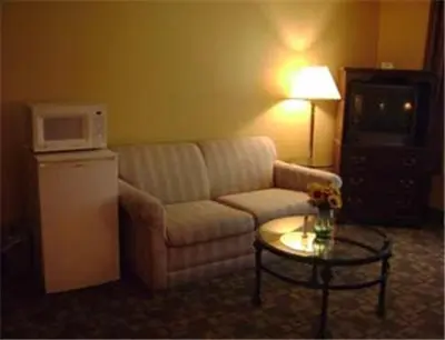 a living room with a couch and a microwave at Knights Inn Hadley in Hadley