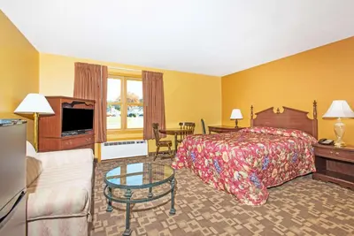 a hotel room with a bed and a television at Knights Inn Hadley in Hadley