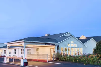 a school building with a blue and white building at Knights Inn Hadley in Hadley